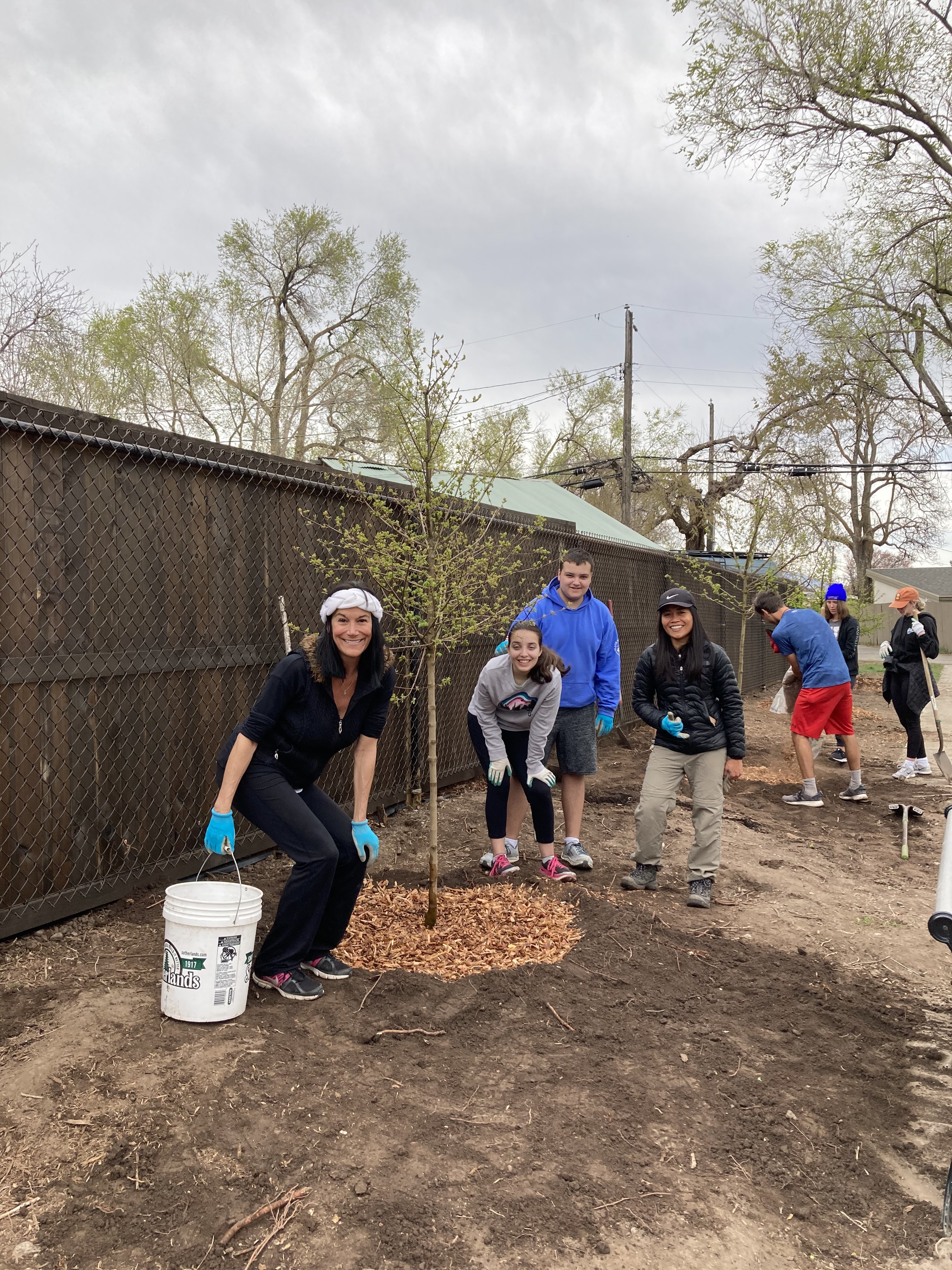 People and kids planting trees